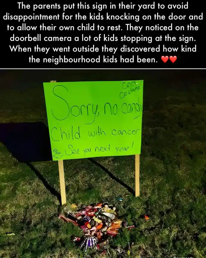 A bright green handwritten sign in a grassy yard reads 'Sorry, no candy. Child with cancer. See you next year!' with smaller…