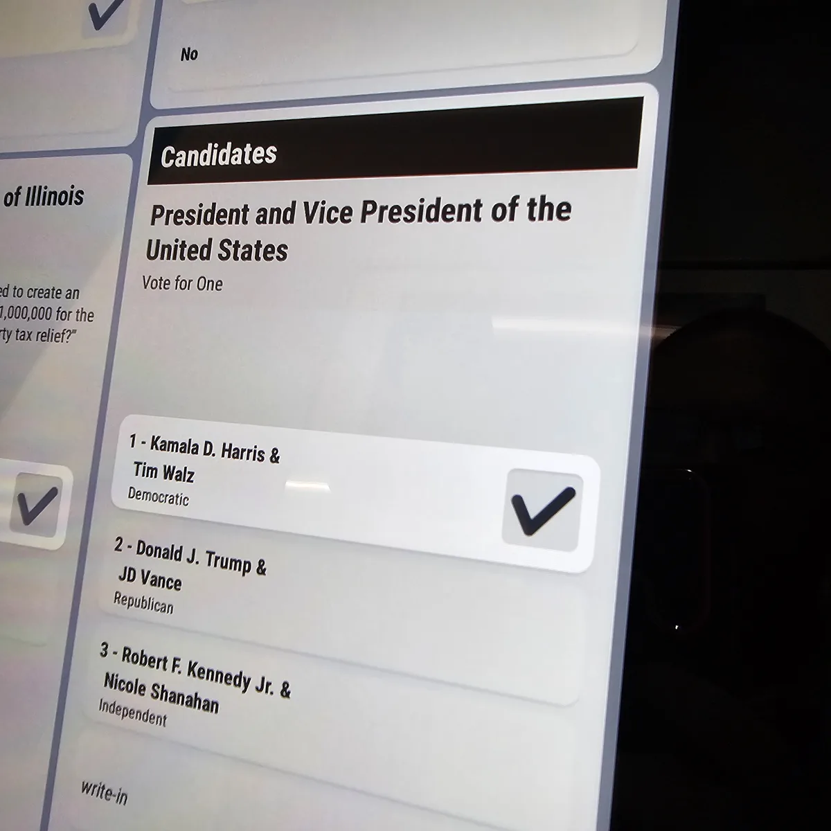 A close-up of a smartphone screen displaying a U.S. presidential election ballot interface. The 'Candidates' section lists…