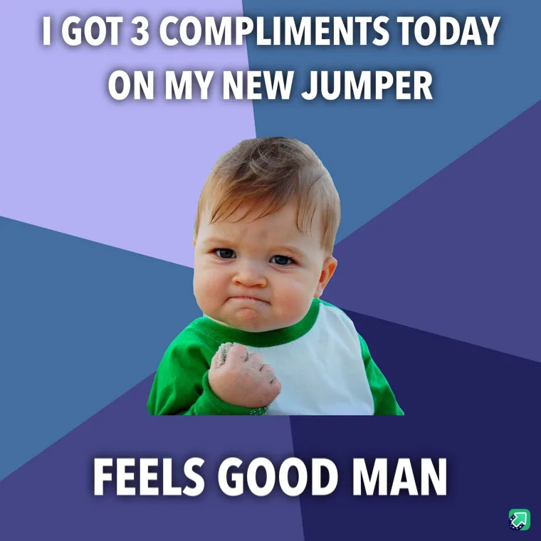 A baby wearing a green and white long-sleeved shirt makes a smug, self-satisfied face while holding a clenched fist. The…