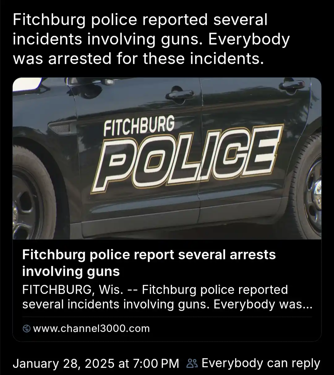 The image shows a close-up of a black Fitchburg Police car with 'FITCHBURG POLICE' written in large white and gold lettering…