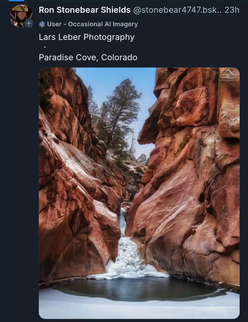 A scenic photograph shows a narrow canyon with reddish-brown rock walls, a small waterfall partially frozen into ice, and a…