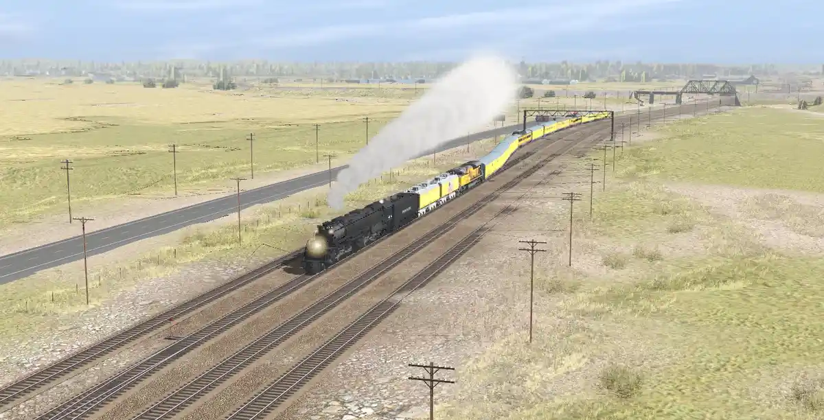 A steam locomotive pulls a long yellow passenger train through a rural landscape with multiple tracks, power lines, and a…