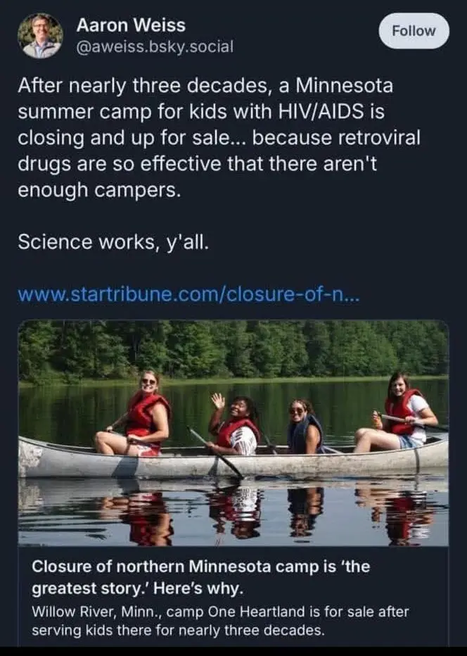 A screenshot of a social media post showing a photo of four young women in a canoe on a lake, all wearing red life vests…
