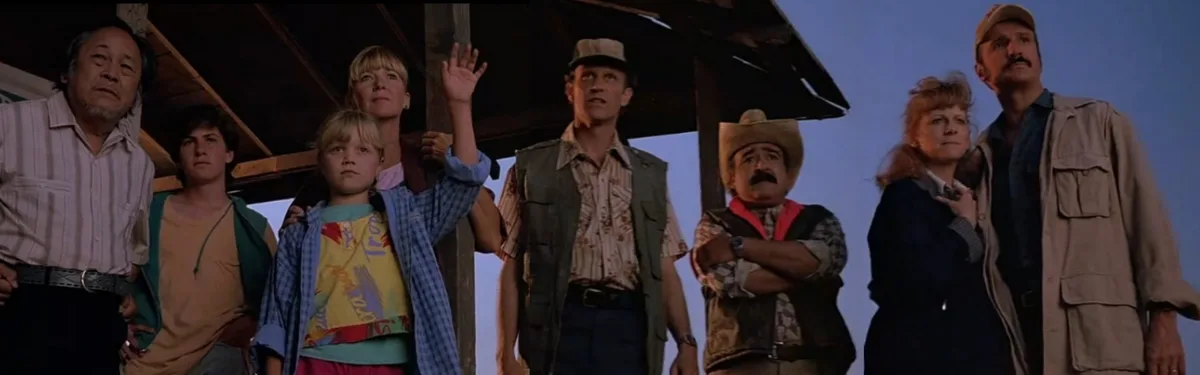 A still from the 1989 film 'The Lost Boys' shows a group of characters standing under a wooden structure, looking upward…