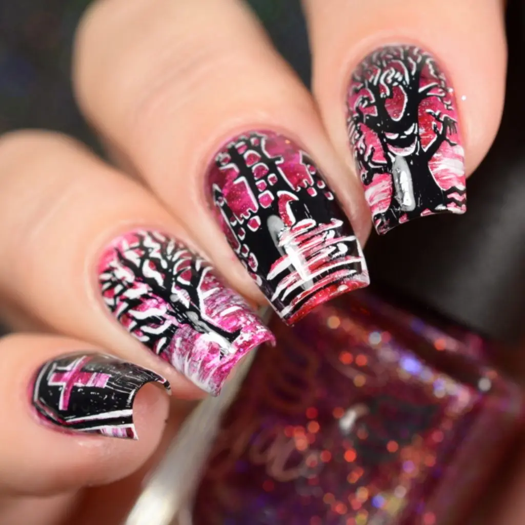 A close-up of a hand with intricately designed fingernails featuring black tree silhouettes against a pink and white…
