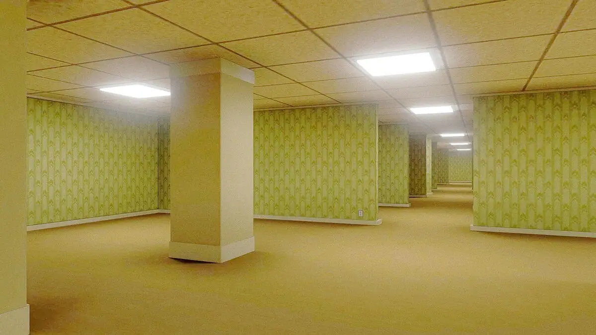 An empty, long hallway with beige carpet, repeating pillars, and walls covered in dated green and beige patterned wallpaper…