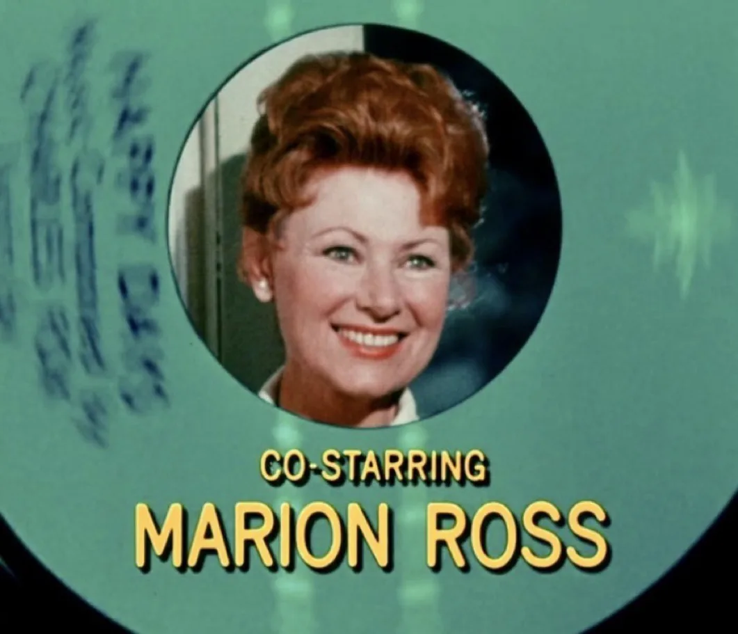 A vintage film credit card featuring a smiling woman with red hair in a circular frame against a teal background with faded…