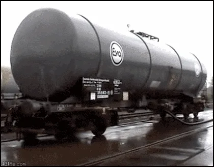 A six-panel sequence shows a tanker train car progressively tipping over and rolling onto its side as it moves along the…