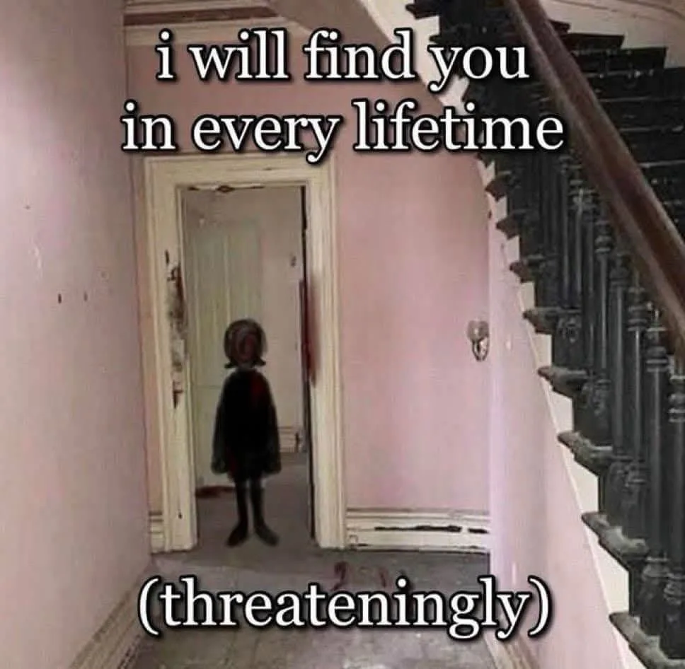 A blurry image of a small child in a dark dress standing in a doorway of a pink-walled hallway, with a staircase visible to…