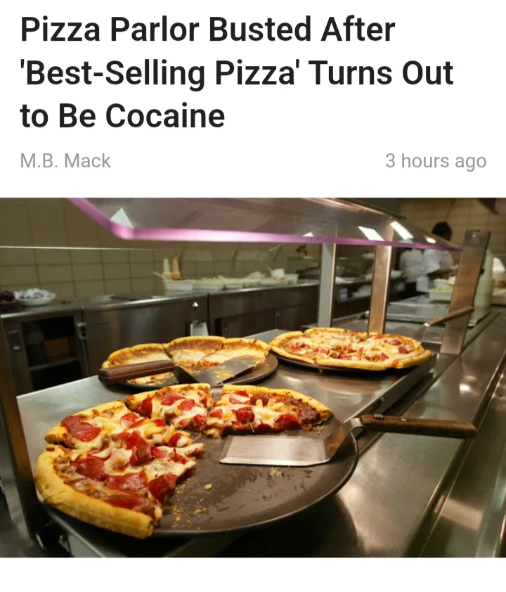 A photo of a pizza restaurant kitchen with several pizzas on metal trays, some partially eaten, under a glass sneeze guard…