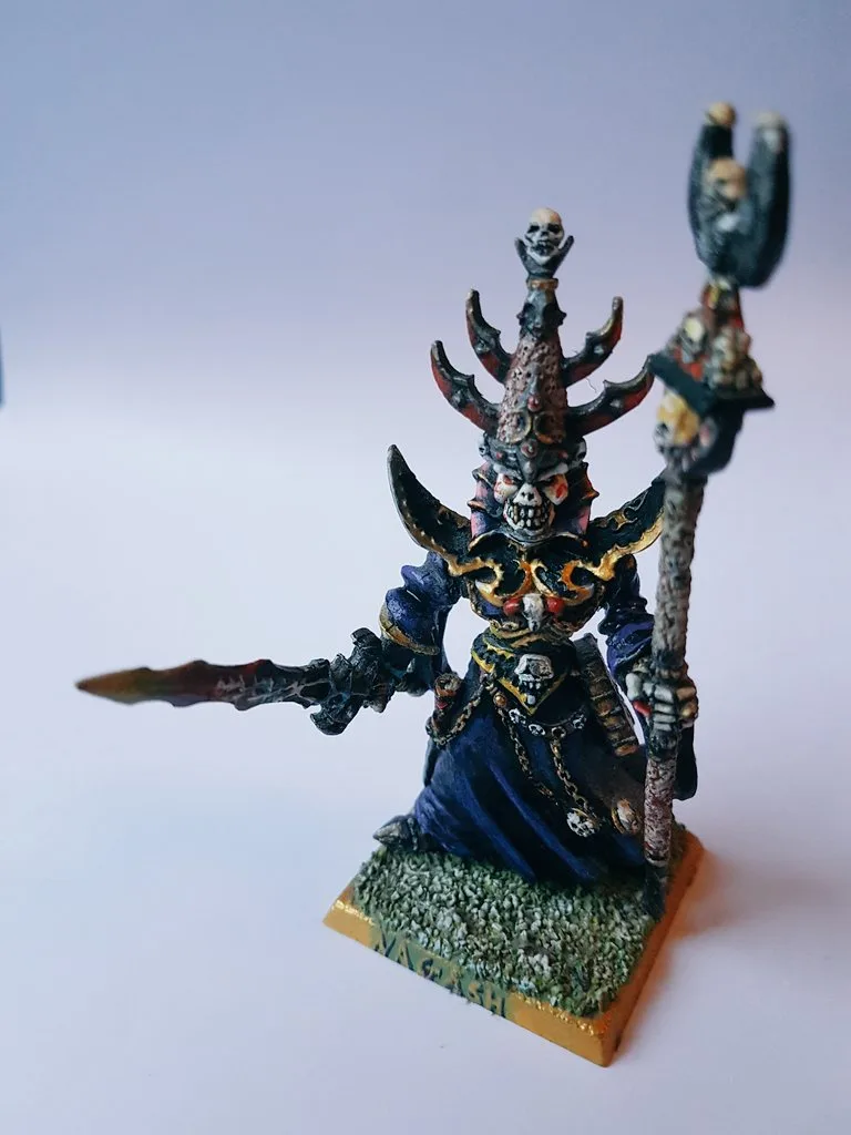 A highly detailed, hand-painted miniature figurine of a dark fantasy warlord or necromancer, wearing ornate skull-adorned…