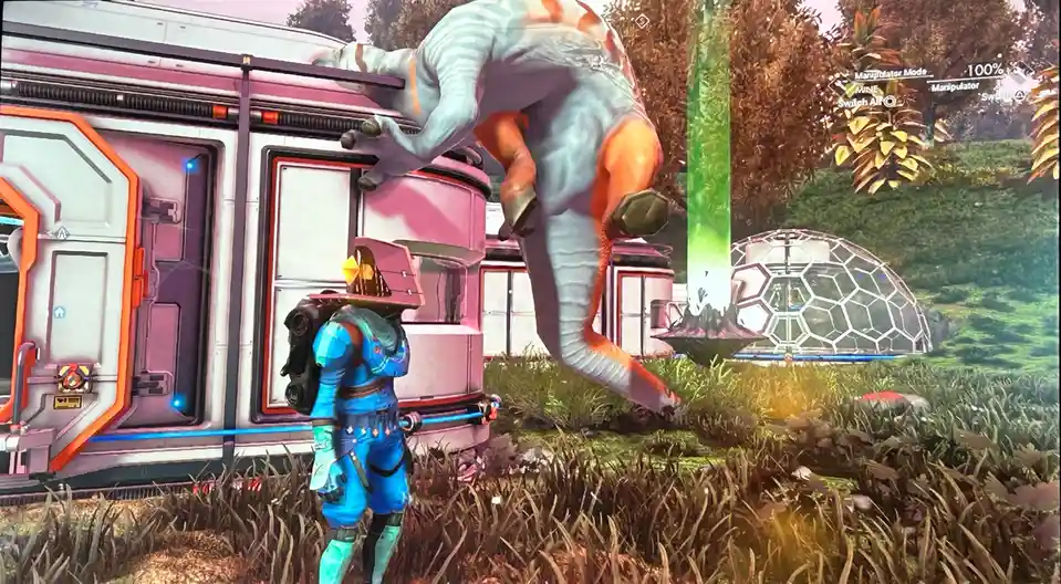 A player character in blue armor stands in a sci-fi game world, looking up at a large, bipedal alien creature with blue and…