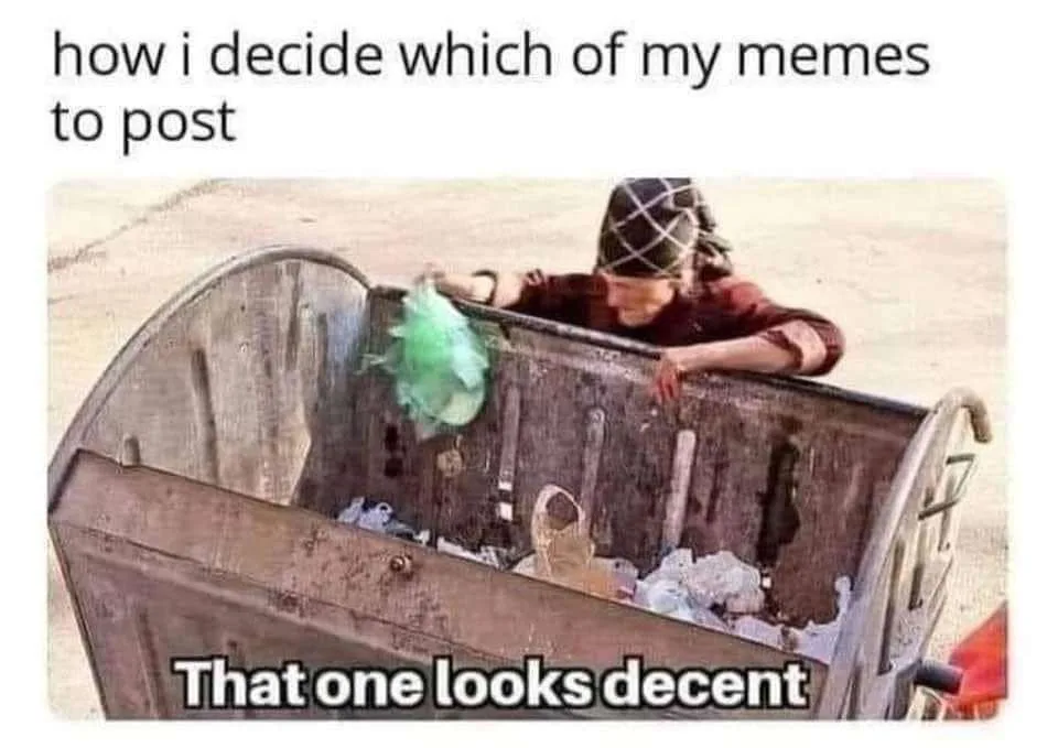 A person wearing a patterned head covering leans over the edge of a large, rusty metal dumpster filled with trash, holding…