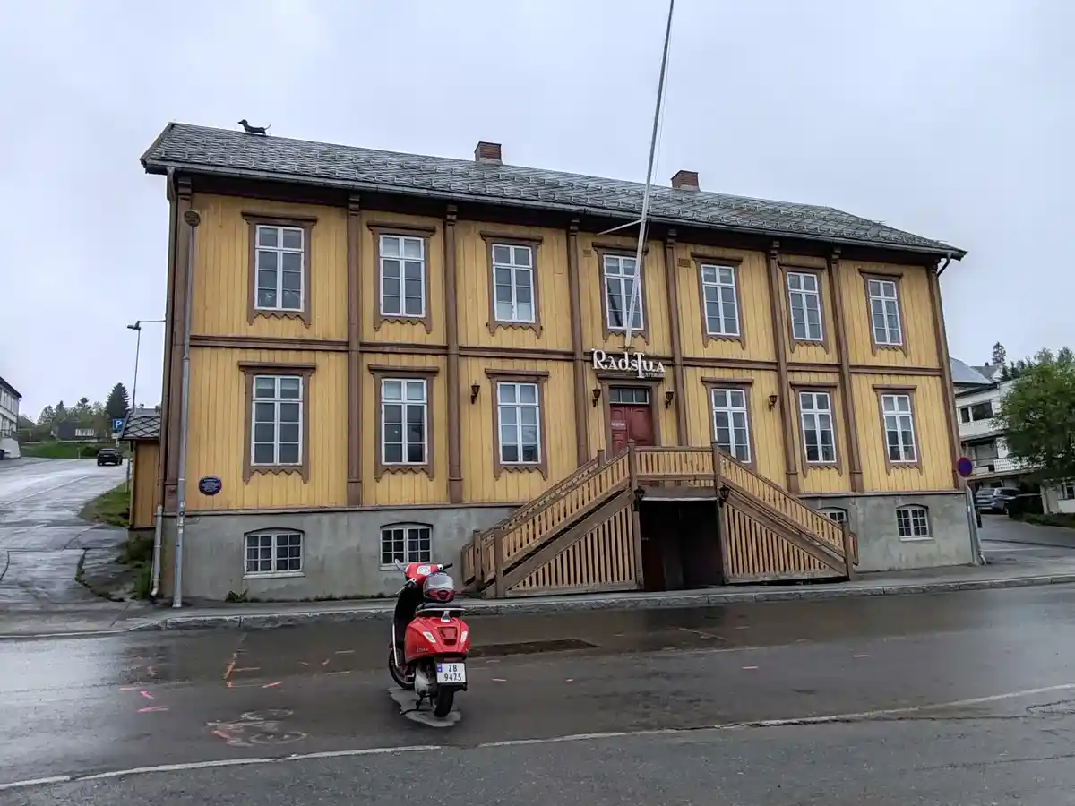 A Charming Scene in Tromso, Norway: The Radstua Theatre with a Dog on the Roof