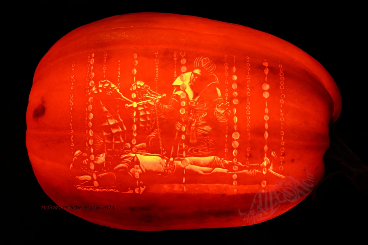 A large, intricately carved pumpkin illuminated from within, displaying a detailed scene of a warrior in armor standing over…