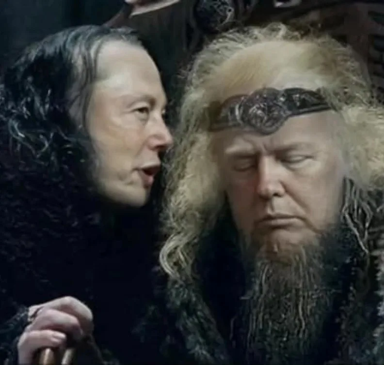 A close-up image shows two men in dark, ornate medieval-style clothing. The man on the left, with dark curly hair and a…