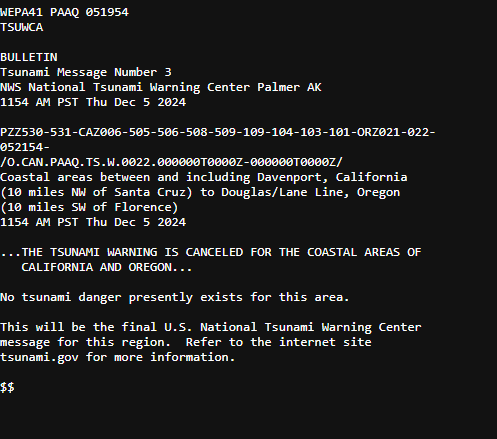A black-and-white image displays a formal-looking tsunami warning bulletin from the U.S. National Tsunami Warning Center…