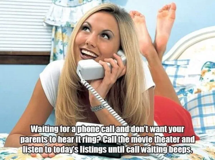A blonde woman lies on a bed with her feet up, smiling happily while holding a white corded phone to her ear. The overlaid…