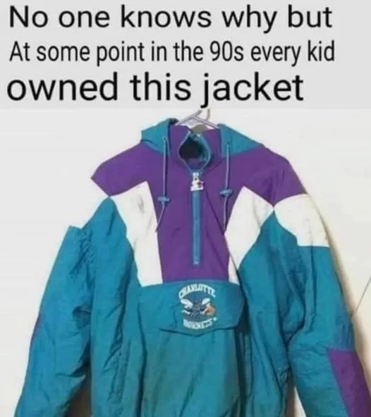 A vintage 90s color-blocked windbreaker jacket with purple, teal, and white panels hangs on a hanger. The jacket features a…