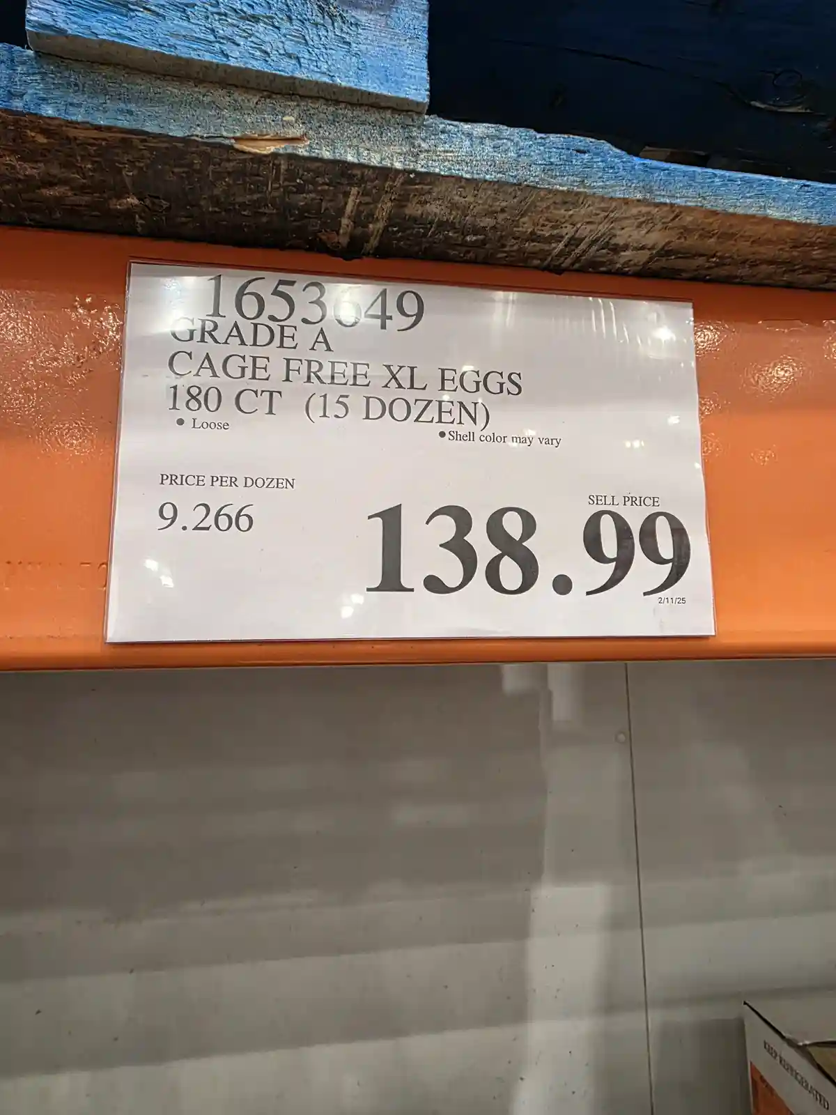 A close-up of a Costco price tag for Grade A cage-free XL eggs, showing 15 dozen (180 count) for a sell price of $138.99…