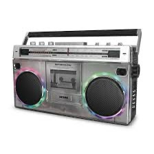 a silver boombox with glowing rainbow lights around its two large circular speakers, featuring a cassette deck and a handle…