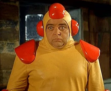 Six panels show a man in a yellow and red robot costume with a helmet, displaying a progression of increasingly alarmed and…