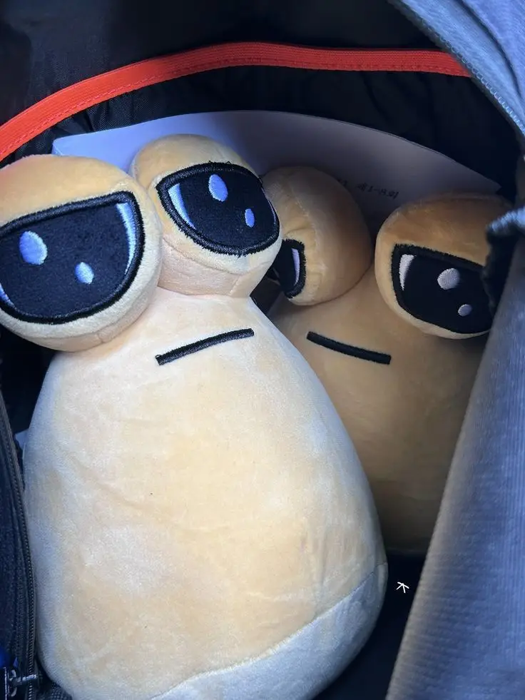 Several beige plush toys with large black eyes and simple stitched mouths are crammed inside a backpack. The plush in the…