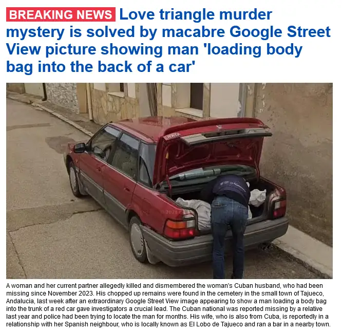 A red car with its trunk open shows a person in a blue shirt and jeans bending over, appearing to load a white body bag into…
