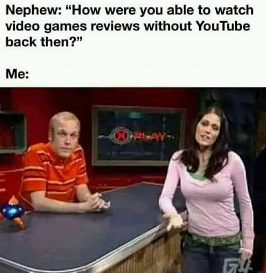 A still from a video game review show features a man in an orange striped shirt looking bewildered while a woman in a pink…