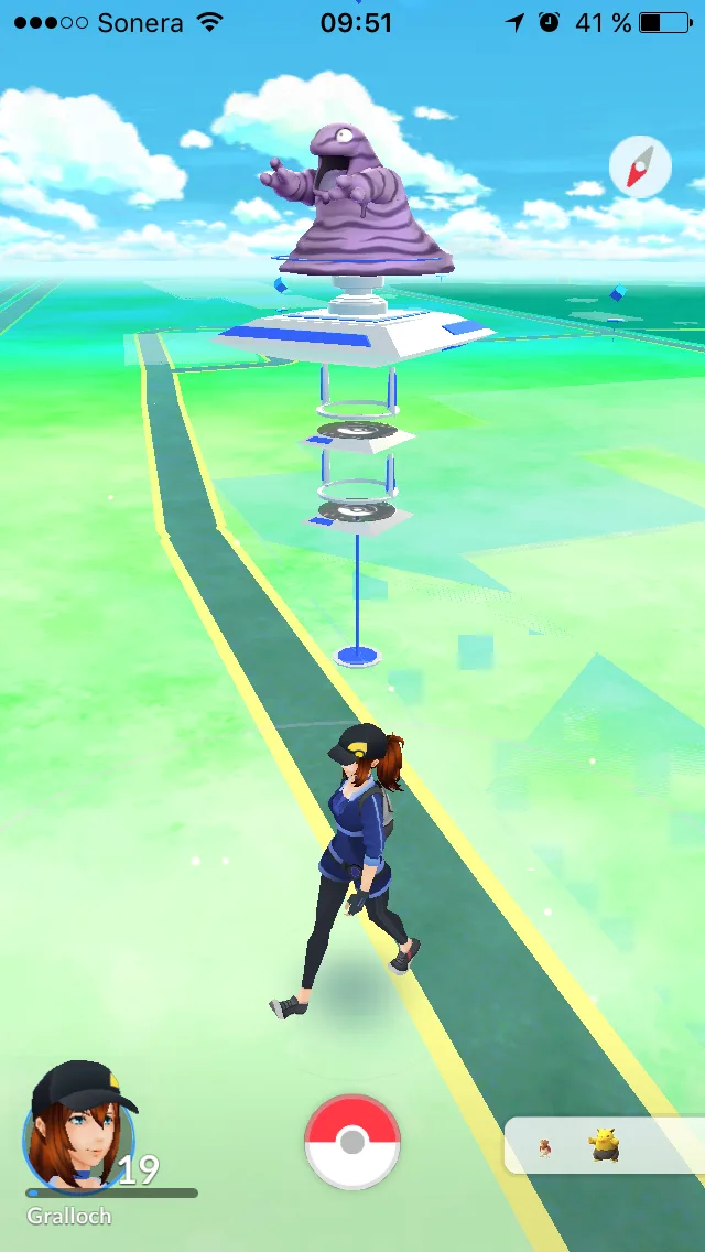 A screenshot from the mobile game Pokémon GO shows a player character walking toward a PokéStop with a large, purple…