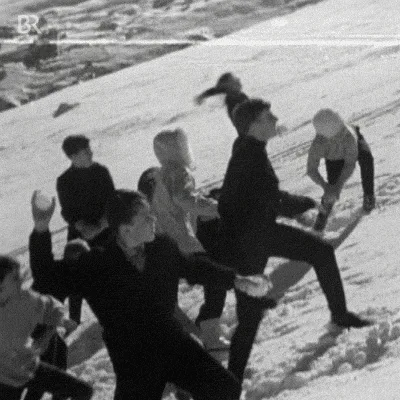 A black-and-white photo sequence shows a group of people on a snowy hill, with one person in the center repeatedly being…