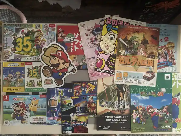 A collection of Japanese Nintendo game promotional materials and stickers, including 'Super Mario Bros. 35th Anniversary'…