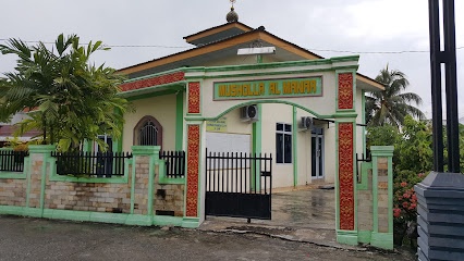 An exterior photo of a small mosque with green and white walls, a black metal gate, and palm trees. The building's sign…