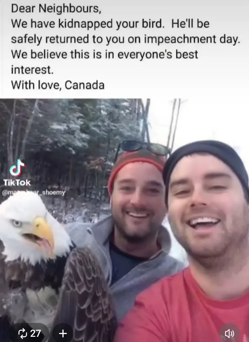 Two smiling men pose for a selfie outdoors in snowy woods, with a bald eagle perched on the left. The image has a text…