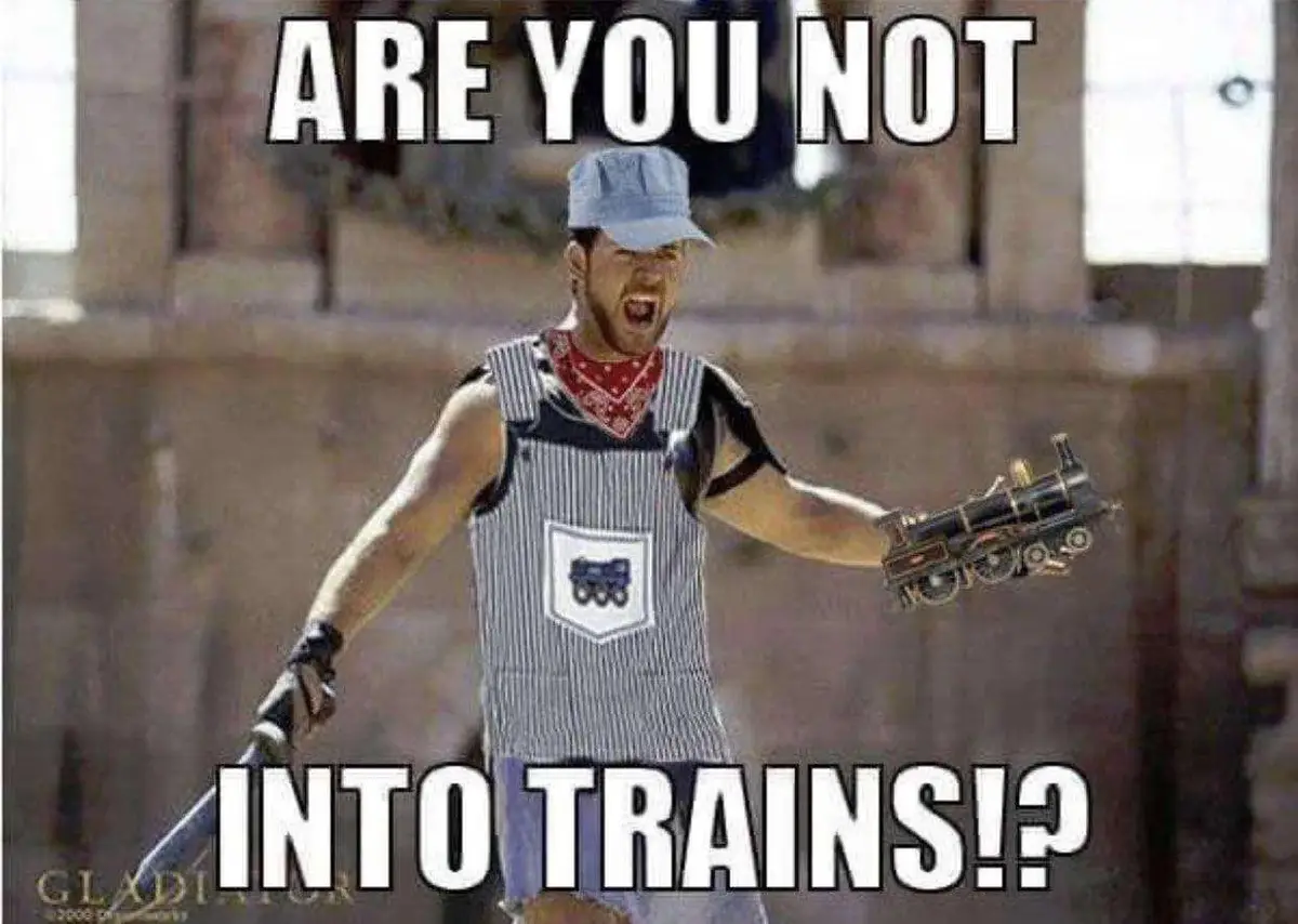 A man in a striped apron and blue cap, holding a toy train and a sword, screams with an angry expression. The overlaid text…