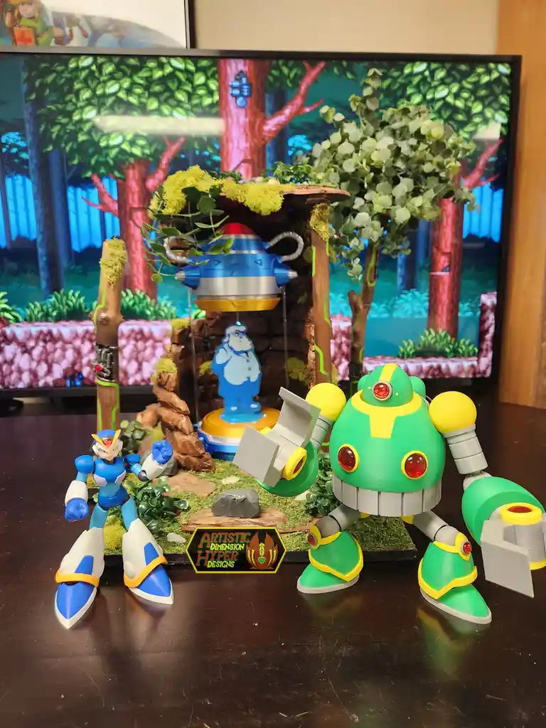 A photo of a custom-built diorama featuring a blue and white Mega Man action figure and a large green and yellow robot…