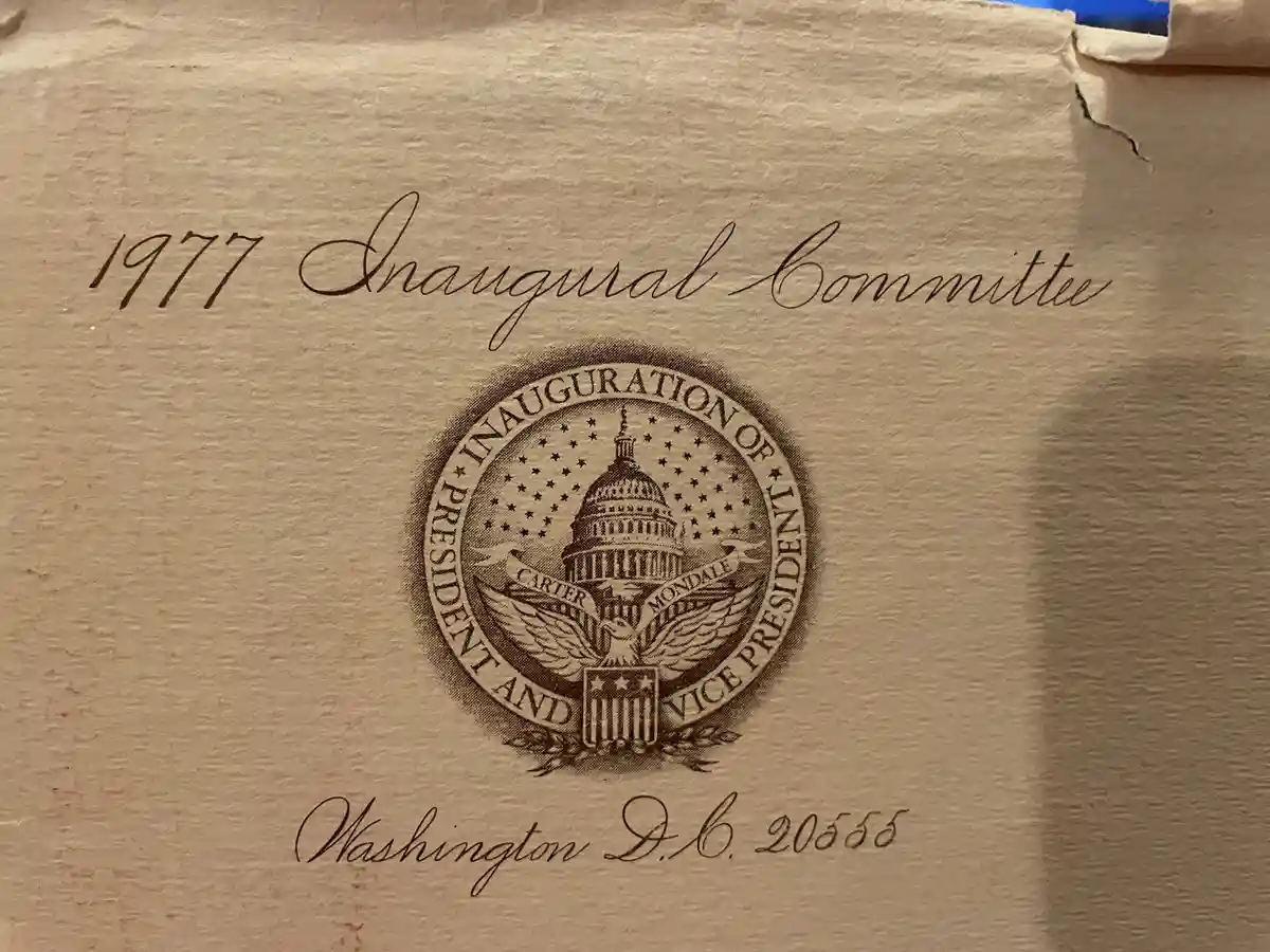 A close-up of a beige envelope with elegant cursive text reading '1977 Inaugural Committee' and 'Washington D.C. 20555'…