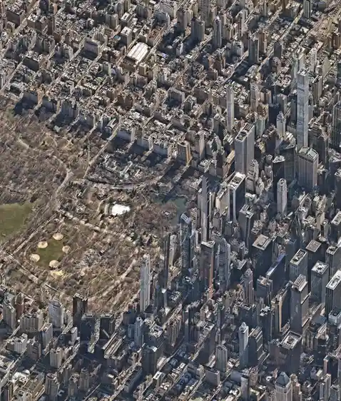 An aerial view of central park in new york city, showing the park's layout surrounded by dense skyscrapers. The overlaid…