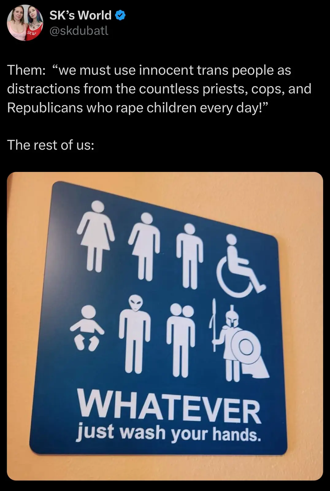 A blue restroom sign with white icons including female, male, and disabled symbols, plus an alien, a baby, a couple, and a…