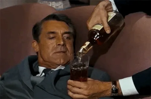 A six-panel image sequence shows a man in a suit reclining on a couch while another person pours liquor into his glass. The…