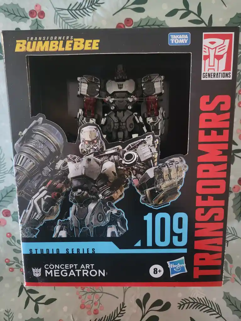 A Transformers toy box for the 'Studio Series' 'Concept Art Megatron' from the 'Bumblebee' movie, featuring a menacing robot…