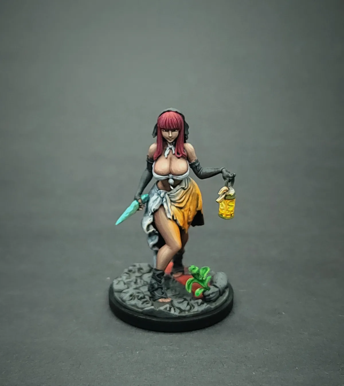 A painted miniature figurine of a female character with red hair, wearing a revealing outfit with a white top and orange…