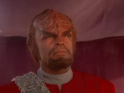 The image displays six panels of a man with a furrowed brow and intense expression, wearing a red uniform with silver…