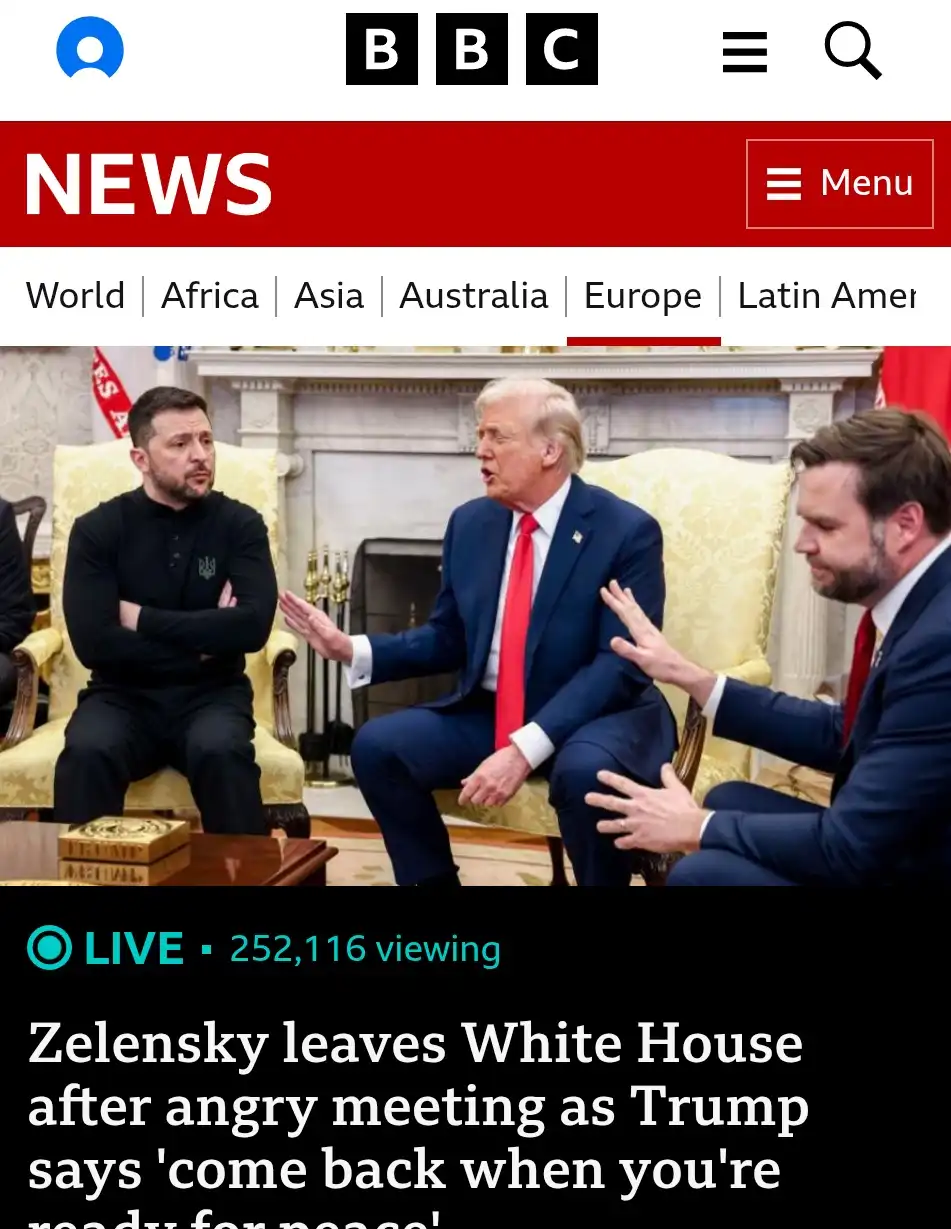 A BBC News screenshot shows Ukrainian President Volodymyr Zelensky sitting with arms crossed, looking displeased, while…