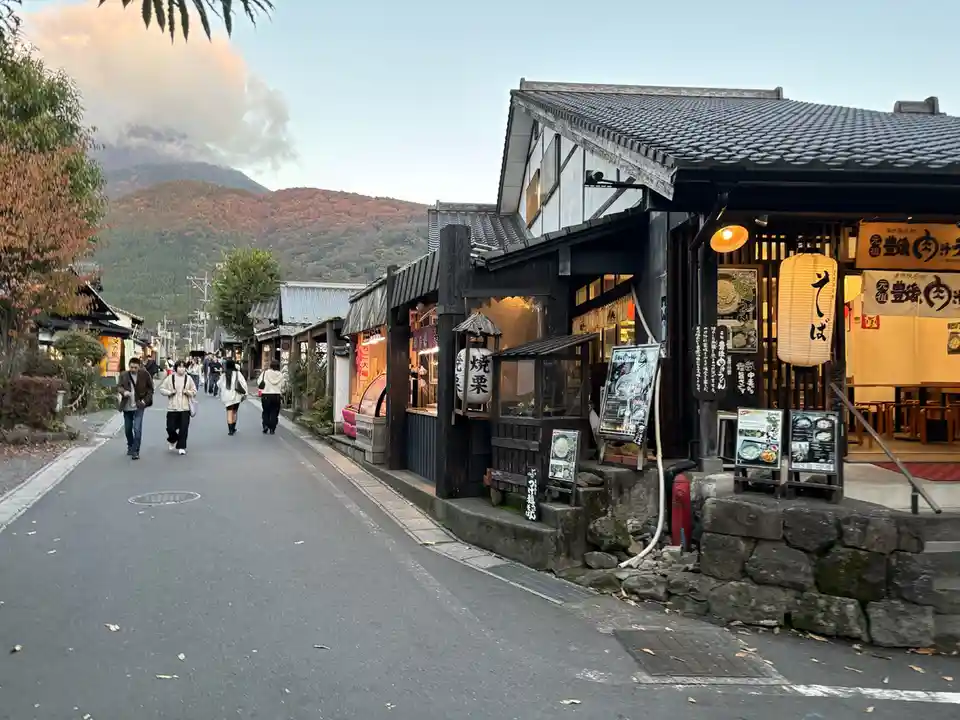 a picturesque street in japan with traditional wooden buildings, lanterns, and people walking, overlaid with the text 'this…