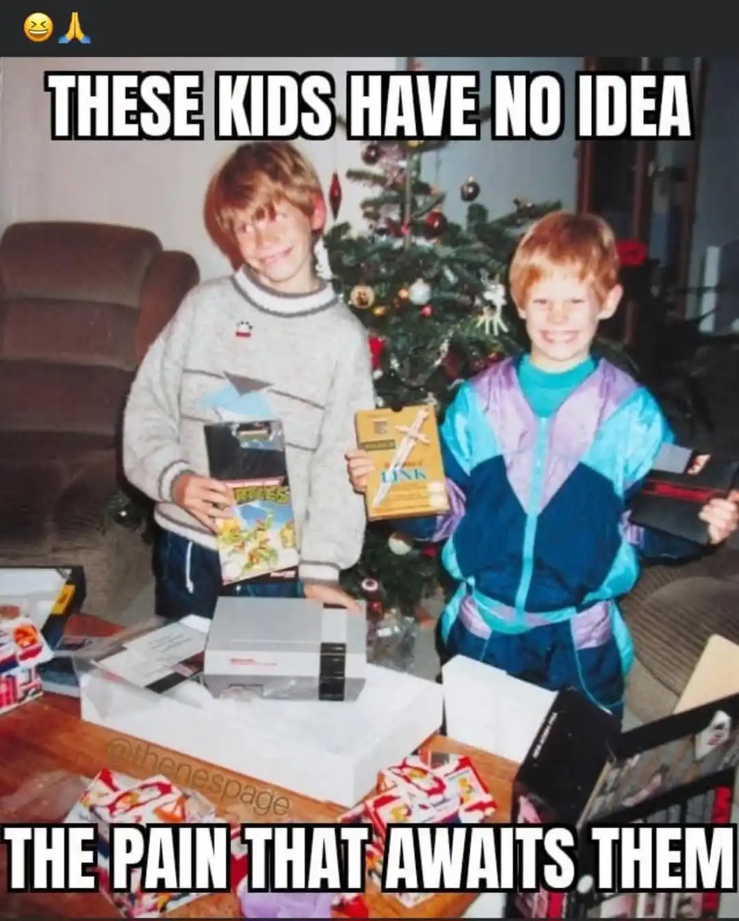 Two smiling children in 1990s clothing stand in front of a decorated Christmas tree, each holding a video game cartridge. A…
