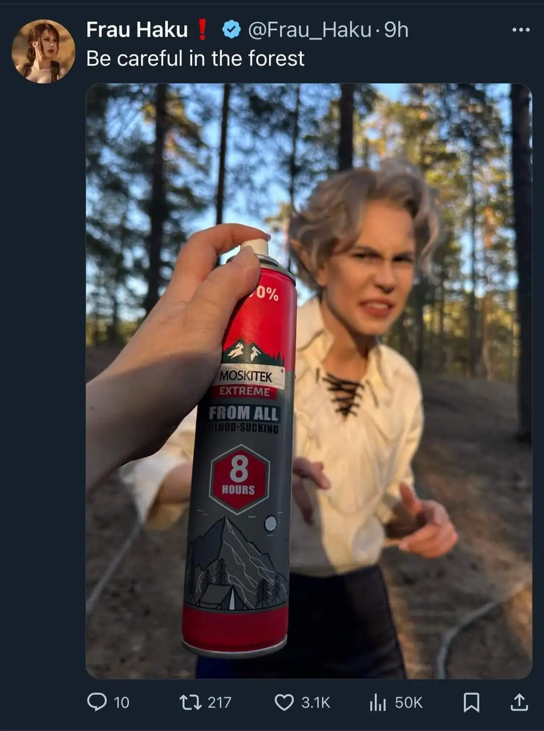 A person with short gray hair and pointed ears, wearing a white laced shirt, stands angrily in a forest background while a…
