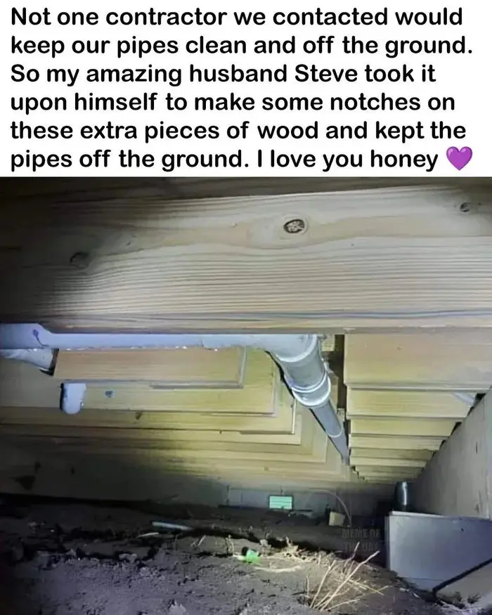 The image shows pipes running under a wooden floor, resting on custom-made wooden notches. The overlaid text describes how…
