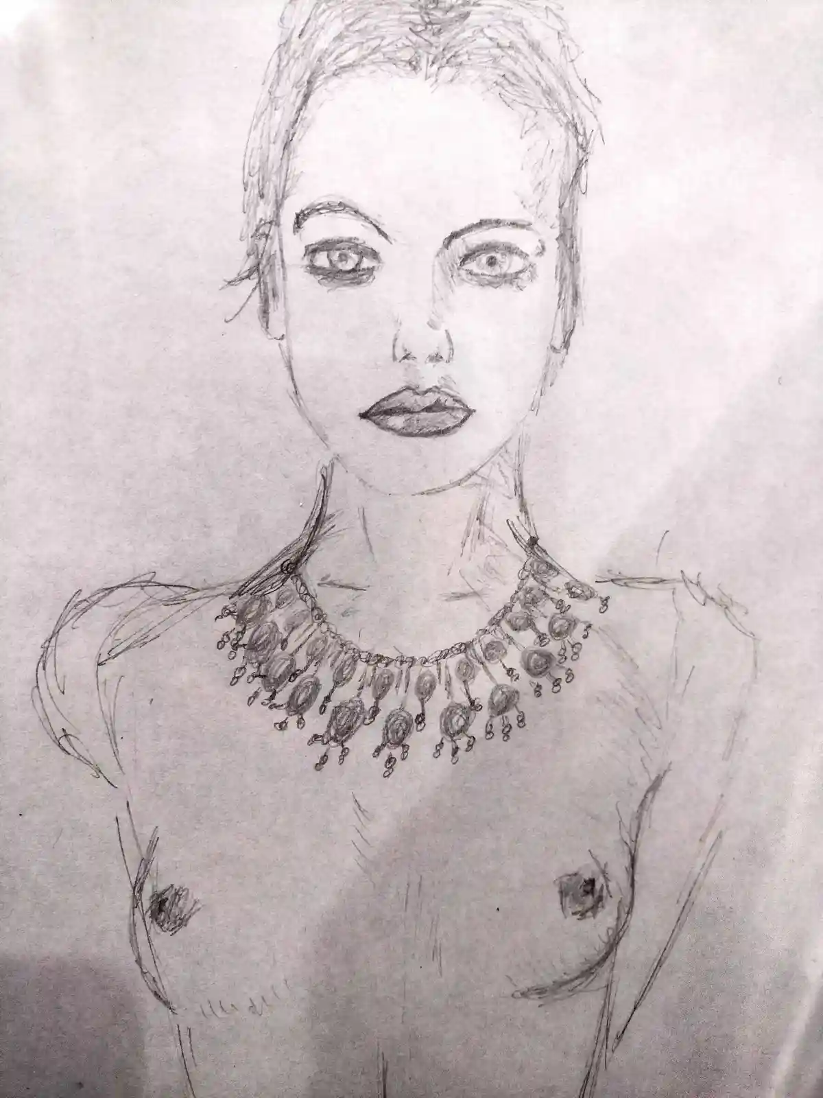 A pencil sketch of a woman's upper torso, showing her face, neck, and bare chest with a detailed ornate necklace. The…