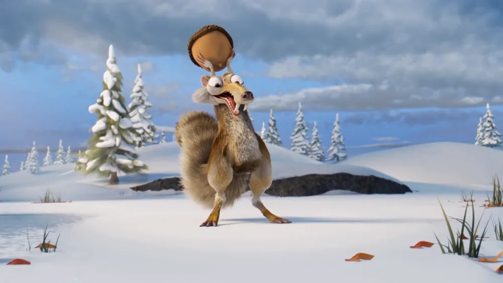 A cartoon squirrel stands in a snowy landscape with snow-covered pine trees, holding a large acorn on its head with both…